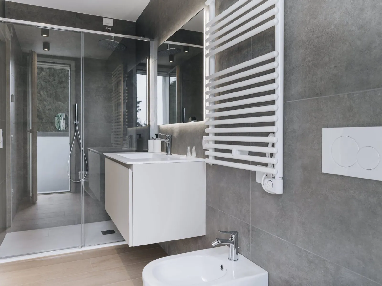 Bathroom with glass shower enclosure, wall-mounted washbasin, bidet and heated towel rail – apartment T-06 Ca' Sette Treviso
